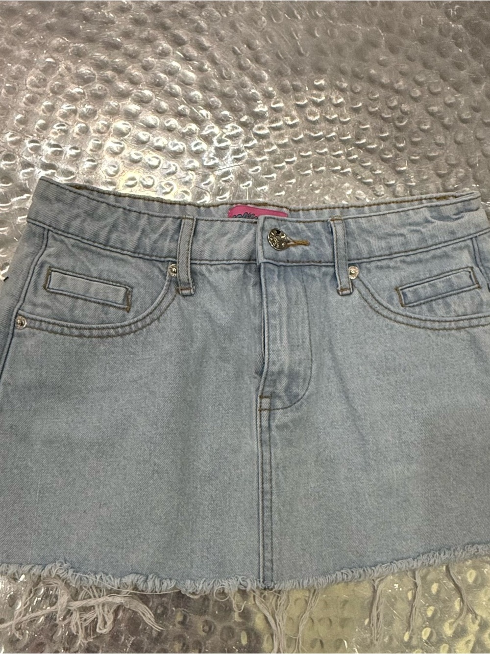 Edikted Light Wash Denim Skirt with Pink Logo Patch